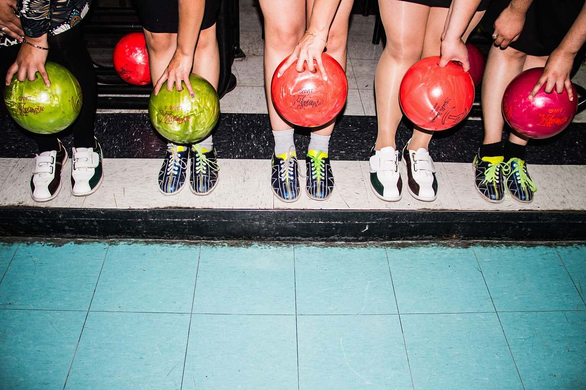 leisure activities person holding bowling balls bowl